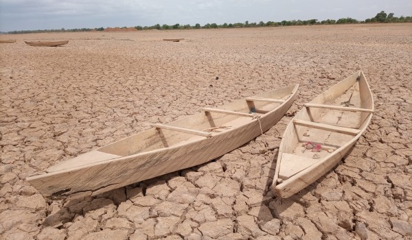 Two boats on a dried up beach